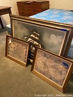 All three items grouped: two framed maps in front, larger ship painting behind