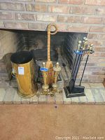 Full view showing brass bucket, brass grate, and cast-iron fireplace tools set in front of fireplace