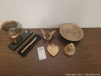 Photo showing all items on a table, including the plate, bowls, letter opener, bell, heart dish, and figurine