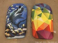 Top view of two kids floating water boards, front side showing colorful shark and geometric patterns