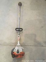 Full view of Stihl FS 56 RC line trimmer showing straight shaft and orange/white body.