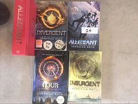 Photo showing all five Veronica Roth novels including Allegiant, Divergent, Four, and Insurgent.