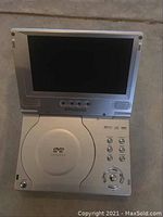 Open view of the Polaroid portable DVD player showing the LCD screen, control buttons, and DVD compartment.