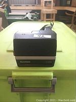 Top-down frontal angle of the Polaroid Sun600 LMS showing branding and partial view of camera body.