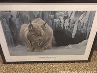 Front view of the framed art print depicting a lynx in a snowy landscape with icicles