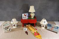Full lot showing cardinal-themed red step stool, lamps, bird books, CD, banner, and stained glass cardinal ornament