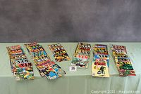 Four stacks of The ’Nam comics laid out side by side on a green cloth