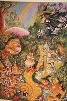 Full view of The Wizard of Oz cat art print showing lion, Dorothy cat, tin man, and witch along yellow brick road with rainbow and castle background.