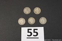 Five Barber/Liberty Head quarters arranged against a black background with a lot number card.