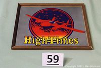 Front of mirror showing red airplane graphic, orange circle background, yellow High Times logo