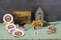 Full group shot of entire lot showing creamers, cheese plates, vintage milk bottle, barn sign, wind chimes with farm animals, flowers, figurines, and other small cow items