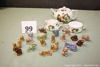 Photo of 20 small Red Rose Tea animal figurines arranged in front of Hammersley Strawberry Ripe bone china tea set components