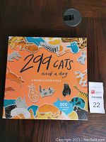 Front cover of the puzzle box with the title '299 cats and a dog' and colorful cat illustrations.
