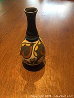 Front view of the vase showing baluster form and colorful abstract Art Nouveau painted design in blue, brown, ochre, and cream