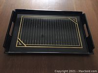 Full top-down view of rectangular black lacquerware serving tray with integrated handles and gold geometric lines.