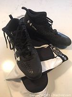 Black Under Armour Nitro Select football cleats with laces and Under Armour logo on upper