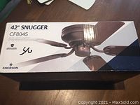 Box labeled '42" Snugger CF804S' showing image of ceiling fan and model information.