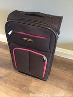 Full front view of the black Racker suitcase showing overall design, size, and condition.