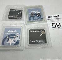 Four sets of magnetic jewelry in original packaging: two Magnetic Body Jewelry sets and two Claire's magnetic earrings sets with floral and star designs.