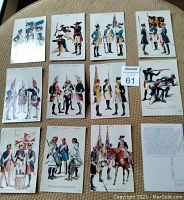Photo showing all 12 vintage military postcards laid out to display full illustrations of soldiers in various historic uniforms and poses