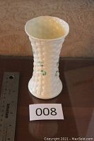 White Belleek porcelain vase with basket weave texture, approximately 5 3/8 inches tall, next to a ruler for scale.