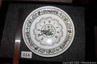 Top view of the Portmeirion Botanical Garden Daisy pattern clock showing floral border and roman numerals.