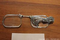 Top view of fully extended lorgnette showing rectangular lenses and decorative handle