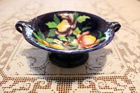 Photo of vintage Maling pedestal dish showing cobalt blue glaze and vibrant peony floral decoration, side angle highlighting handles and pedestal base.