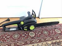 Full view of Poulan 3.5HP electric chain saw on carpet