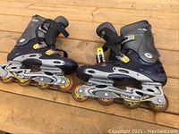 Pair of men's inline rollerblades shown from side angle, illustrating wheel condition and boot details