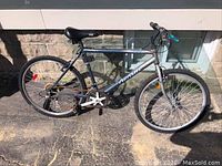 Side view of the grey Arashi adult bike showing frame, seat, tires, and handlebars.