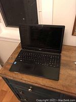 Front view of Acer laptop open showing keyboard and screen.