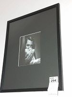 Photo showing the first framed print angled view with mat and black frame.
