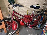 Full side view of red Diamondback Wildwood mountain bike showing overall frame, wheels, and saddle.