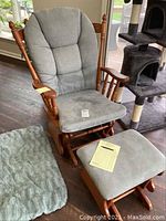 Glider chair and footstool with grey fabric cushions on oak frames, showing overall view.