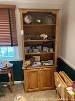 Full front view of oak bookcase showing overall appearance and shelf layout