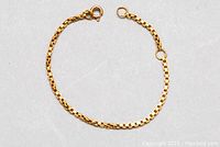 Full view of the 5.5 inch 10kt gold baby bracelet laid flat, displaying the box chain link style and clasp.