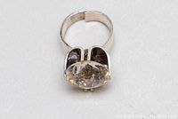 Top angle view showing large round clear aqua gemstone set in 925 sterling silver.