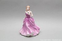 Front side view showing full figure with detail on pink dress and facial features.