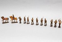 Full line up of approximately 12 WWI German military elastolin toy figurines and horses showing wear and detailed painting