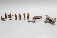 Overview photo of all items in the lot including soldiers, horse, and plane.