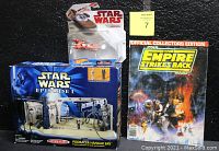 Photo of the three main items in the lot including sealed Podracer Hangar Bay playset, Star Wars Empire Strikes Back magazine, and Hot Wheels Luke Skywalker's Landspeeder.