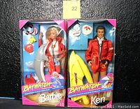 Front view of both Mattel Baywatch lifeguard Barbie and Ken dolls in original packaging showing doll outfits and accessories.