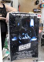 Front view of laminated Star Wars The Empire Strikes Back poster held upright showing full design and lamination.