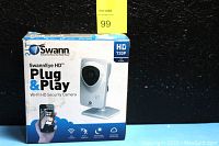 Front view of original retail box showing SwannEye HD Plug & Play Wi-Fi HD Security Camera image, 720P HD resolution indicator, and app usage.