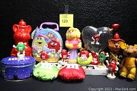 Wide shot showing full lot of M&M's collectibles and other vintage figures.