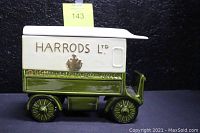 Side view of green and cream ceramic trolley car showing Harrods Ltd and Brompton Road embossed on the side