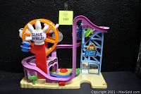Overview of the Fisher Price Imaginext SpongeBob SquarePants Glove World Playset showing the slides, Ferris wheel with 'GLOVE WORLD!' hand feature, and base with play details.