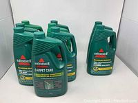 Group photo of nine Bissell carpet cleaning solution bottles showing the front.