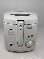 Front view of white T-Fal Family Deep Fryer showing control panel with temperature dial, indicator lights, and power switch